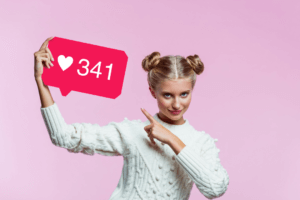 woman on pink background holding a sign with 341 likes