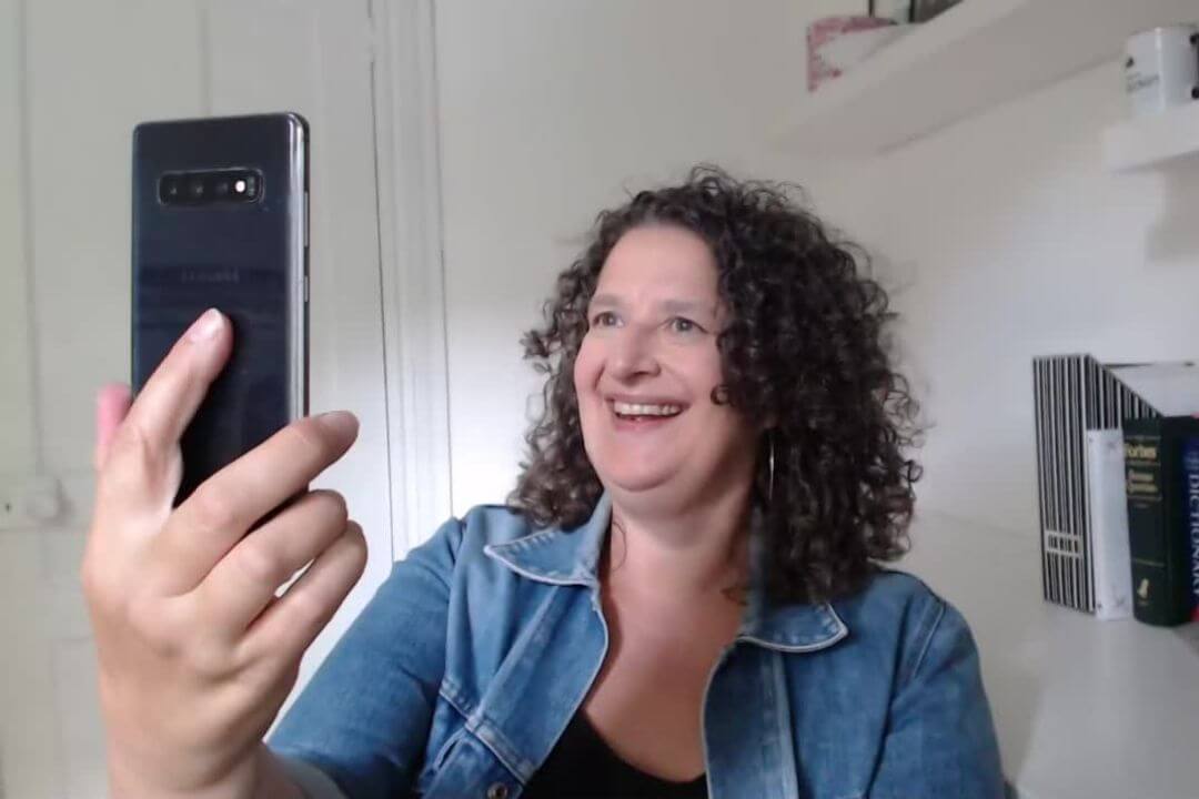video marketing expert Andrea Stenberg records an Instagram Reel using her smartphone